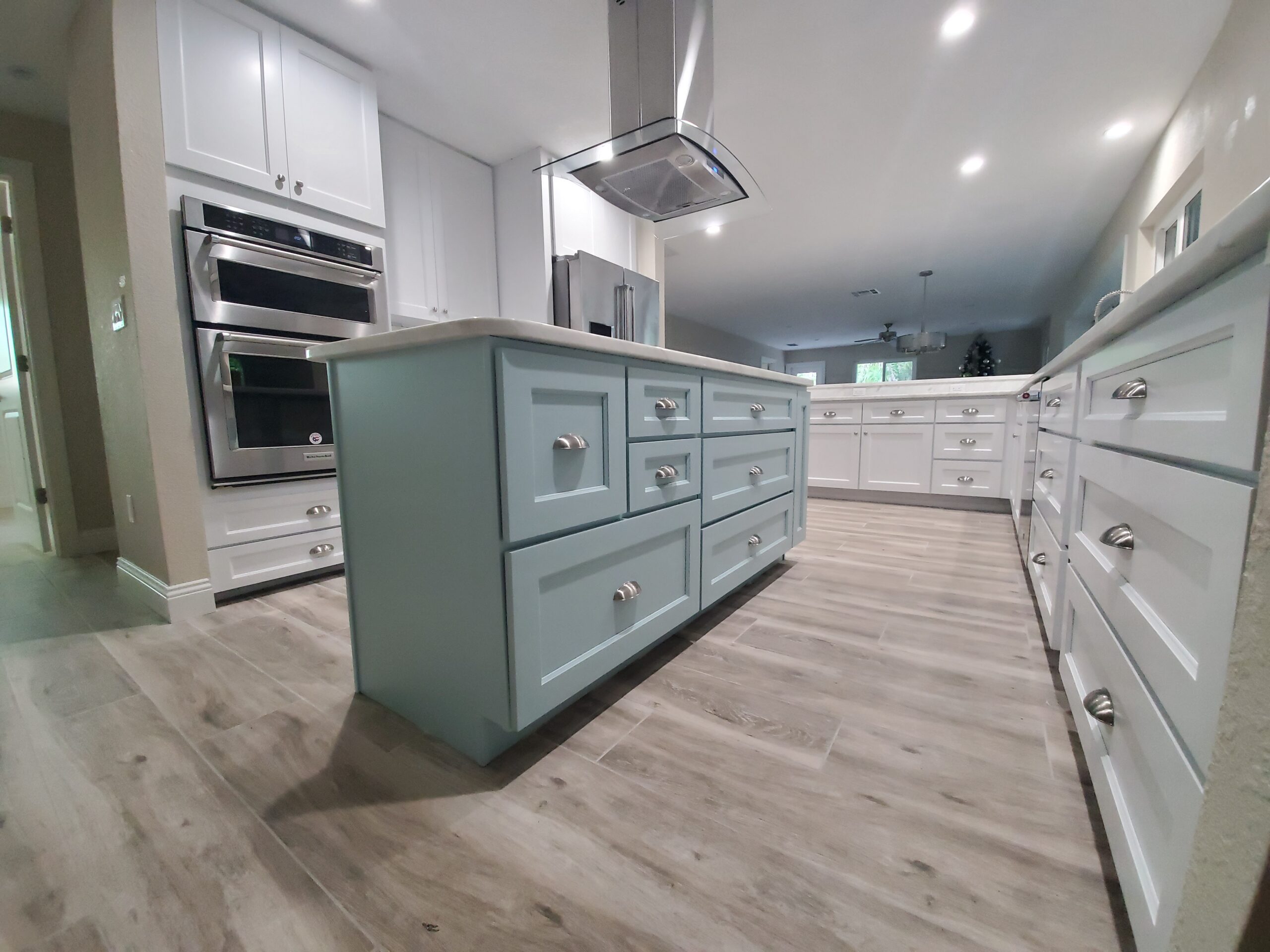 White kitchen with soft blue island